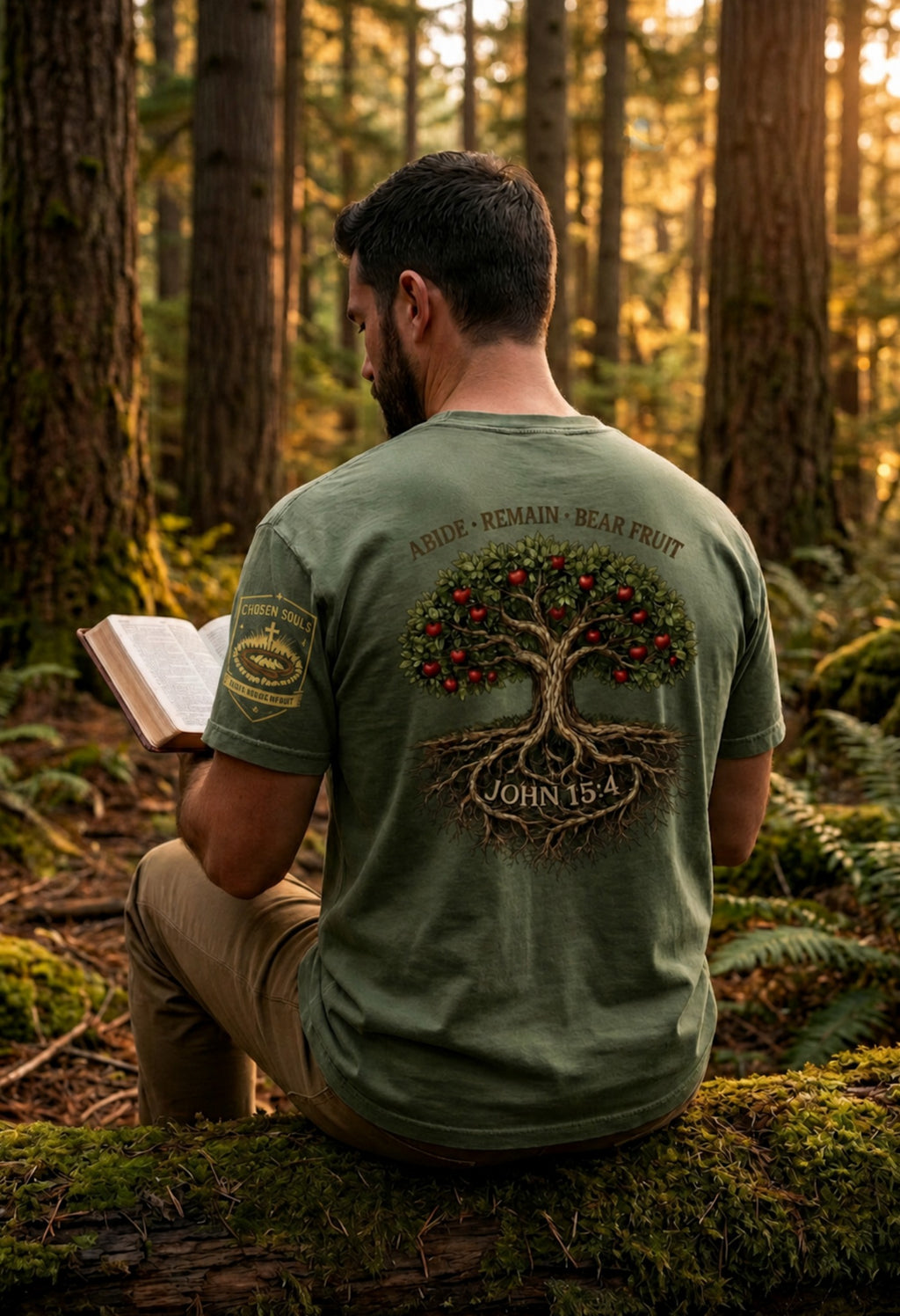 Man wearing Abide Remain Bear Fruit John 15:4 Comfort Colors 1717 Moss Christian t-shirt in a forest