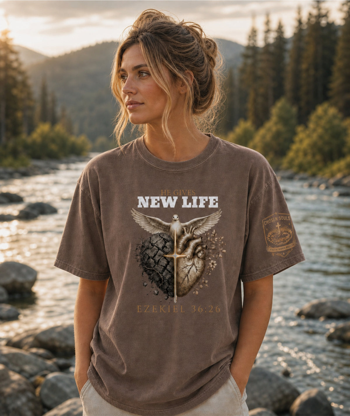 Woman wearing He Gives New Life Ezekiel 36:26 Comfort Colors 1717 Espresso Christian t-shirt outdoors