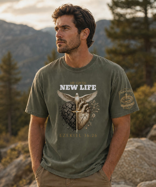 Man wearing He Gives New Life Ezekiel 36:26 Comfort Colors 1717 Moss Christian t-shirt outdoors