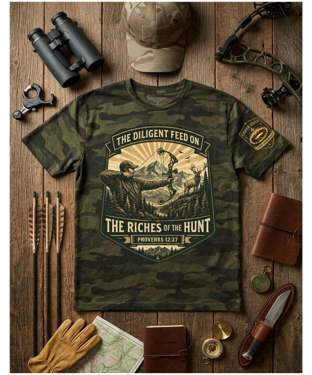 The Riches of the Hunt Proverbs 12:27 Forest Camo Christian bowhunting t-shirt premium hunting flat lay